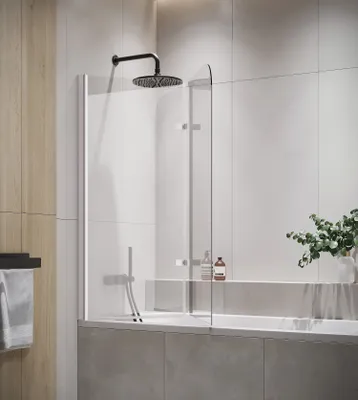 A modern bathroom with a bathtub and a shower screen.