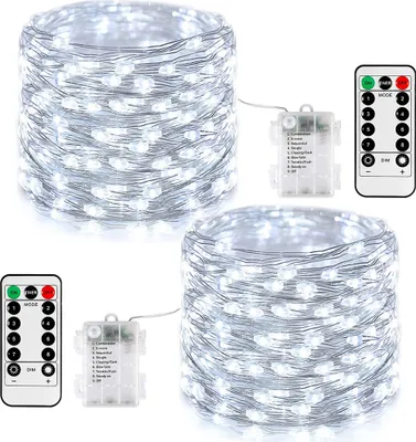 Two spools of white LED string lights with battery packs and remote controls.