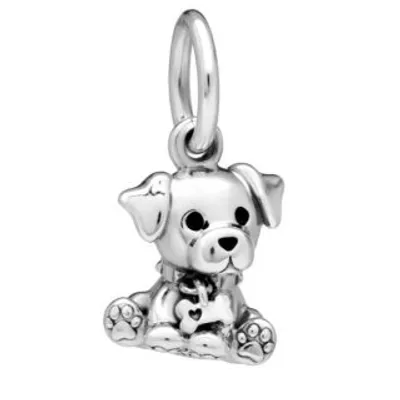 A silver charm in the shape of a sitting puppy with a bone-shaped tag on its collar.
