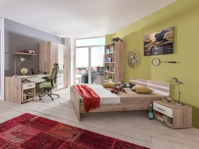 A bedroom with a bed, desk, and wardrobe.