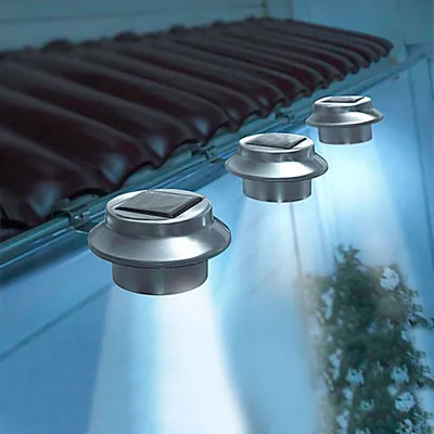 Solar-powered lights attached to a roof gutter, illuminating the area below.