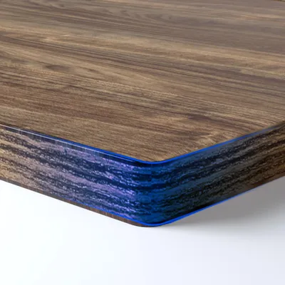 Close-up of a corner of a wooden tabletop with a blue edge.