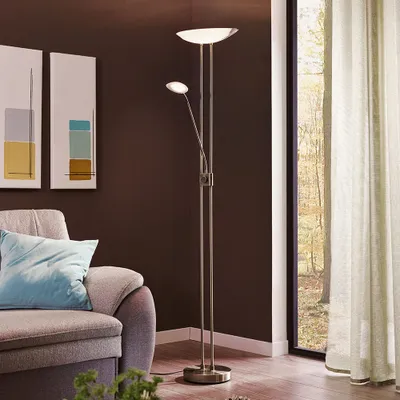 A modern living room with a sofa, artwork, and a floor lamp.