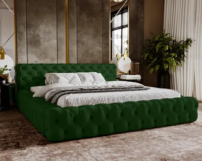 A luxurious bedroom setting with a green velvet tufted bed as the focal point.