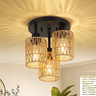 A close-up shot of a three-light ceiling fixture with woven rattan shades, casting patterned light on the ceiling.