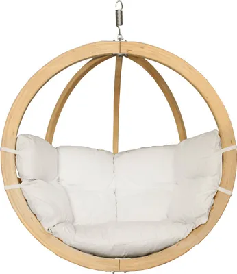 A hanging chair with a white cushion, suspended by a spring and metal chain.