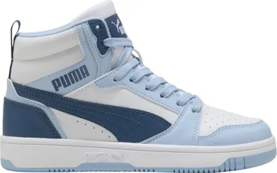 A studio shot of a single Puma Rebound V6 Mid Jr sneaker.
