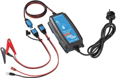 A battery charger with cables and connectors is laid out on a white background.