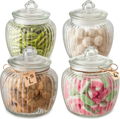 Four glass jars filled with different food items, arranged in a grid.