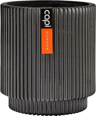 A dark gray cylindrical planter with vertical ribbed texture and a brand label.