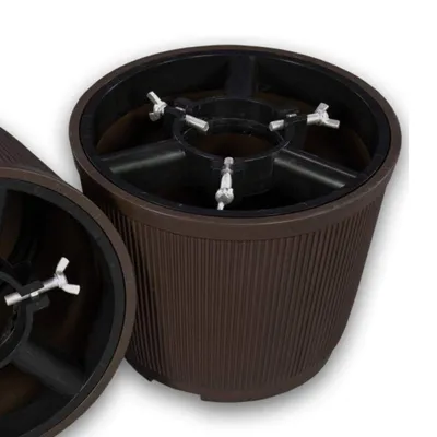 Two brown Christmas tree stands are shown against a white background.