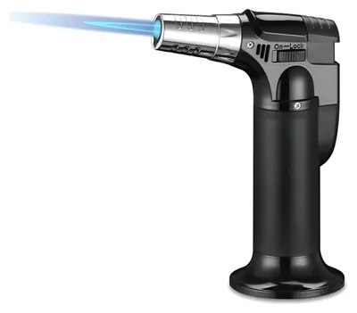 A black and silver butane torch lighter with a blue flame emitting from the nozzle, set against a white background.
