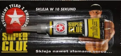 A blister pack containing a tube of Super Glue, with a stylized image of a muscular man on the packaging.