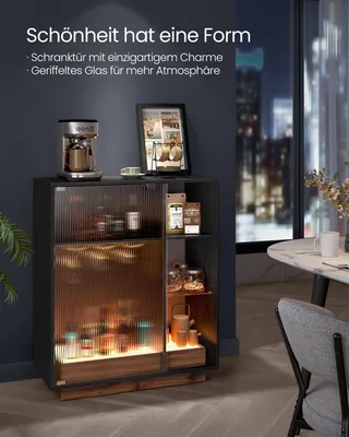 A dark, modern interior with a cabinet filled with bottles and jars, illuminated by soft lighting. A table and chair are visible in the background.