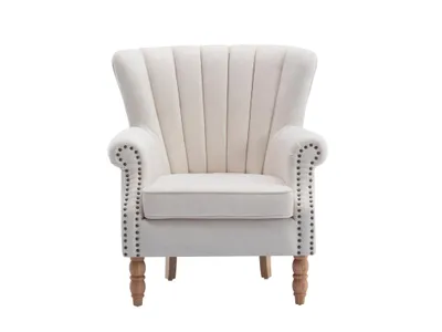 Produktbild von Sessel aus cremefarbenem Stoff mit BATOUMI-Nietenbesatz
