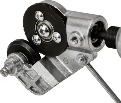 Close-up of a metal adapter with gears and rollers.