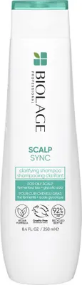 A white bottle of Biolage Professional Scalp Sync Clarifying Shampoo is shown against a white background.