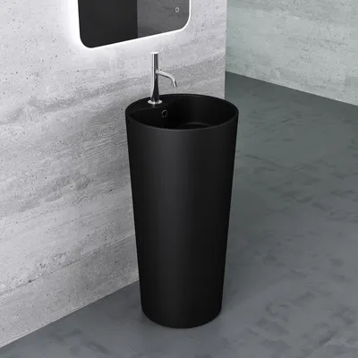 A black freestanding sink with a chrome faucet is shown in a modern bathroom with concrete walls and floor.