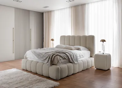 A bedroom with a bed, nightstand, and wardrobe.