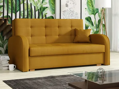 A mustard-yellow sofa is shown in a living room setting with a tropical-themed wallpaper and a wooden staircase.
