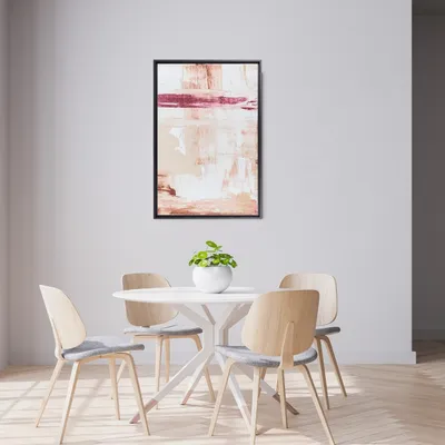 A modern dining area with a round white table and four wooden chairs, featuring a framed abstract painting on the wall.