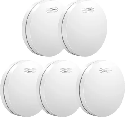 A group of five white smoke detectors arranged in two rows on a white background.