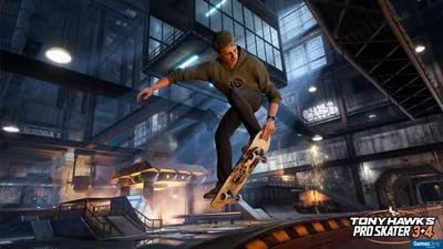 A skateboarder performing a trick in an indoor skatepark.