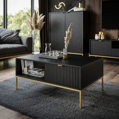 A modern living room with a black coffee table, sofa, and cabinets.