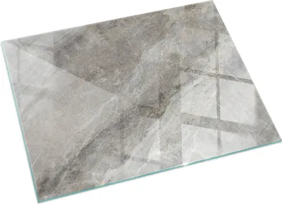 A rectangular glass cutting board with a marble-like pattern.