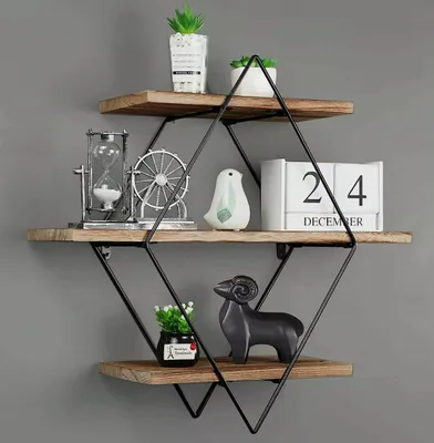 A three-tiered wooden shelf with decorative items on each shelf, mounted on a gray wall.