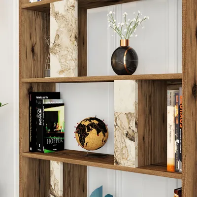 A close-up view of a wooden bookshelf with decorative marble accents and various items on its shelves.