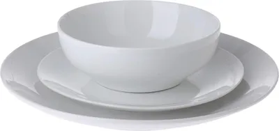 A white ceramic bowl and two plates stacked on top of each other against a white background.