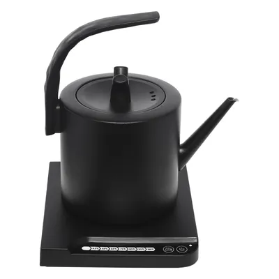 A black electric kettle with a gooseneck spout sits on its charging base.