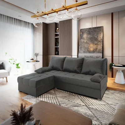 A modern living room with a sectional sofa as the main focus, placed on a patterned rug.