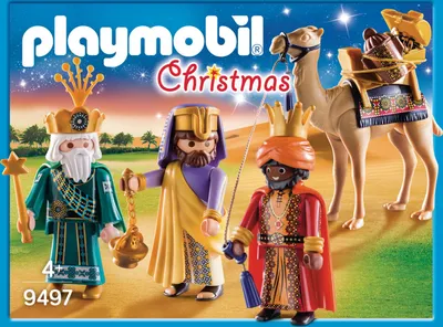 The image shows a Playmobil Christmas set featuring the Three Wise Men and a camel, presented on a desert-like background with a starry sky.