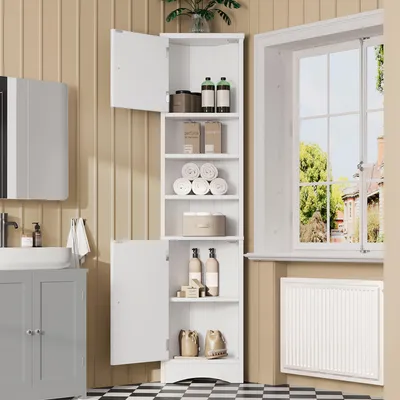 A white corner cabinet with multiple shelves and doors, filled with bathroom items, is shown in a bathroom setting next to a window.