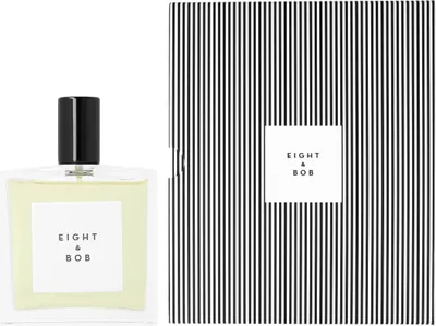 A perfume bottle and its packaging are displayed side-by-side against a white background.