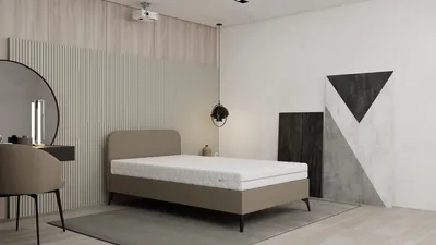 A bedroom scene with a bed, vanity, and abstract art.