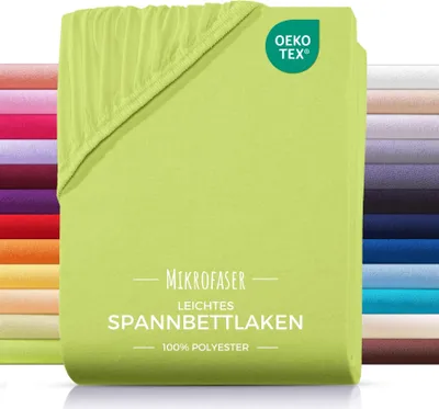 A folded green fitted sheet is shown, with a stack of other colored sheets in the background.