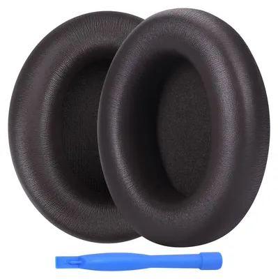 Two brown ear pads for headphones and a blue plastic tool.