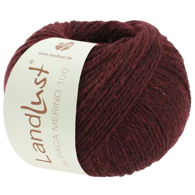 A ball of burgundy yarn with a label.