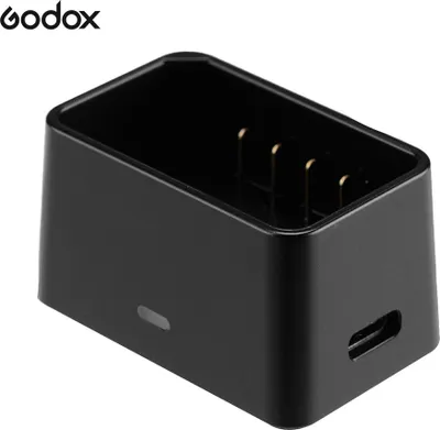A black Godox VC26 USB charger for Godox V1 series camera flashes.
