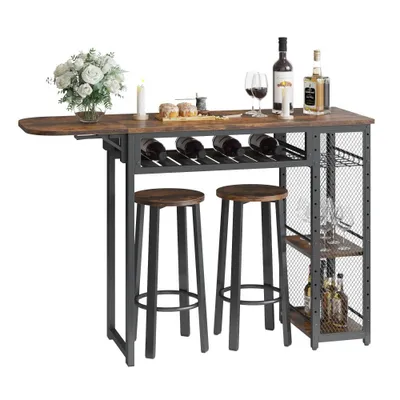 A bar table with two stools, wine bottles, glasses, and decorative items.