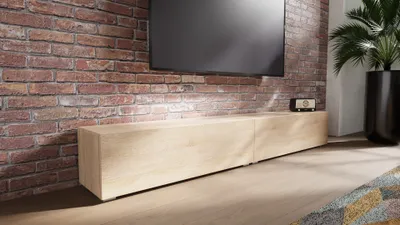 A modern TV stand against a brick wall, with a TV mounted above it.