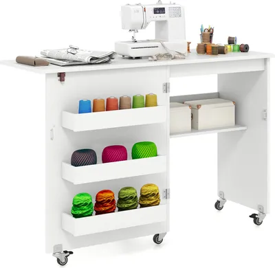 A white sewing table with a sewing machine on top and various spools of thread stored in shelves on the side.