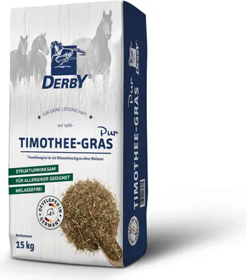 A bag of horse feed with a pile of hay in front of it.