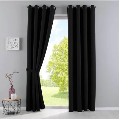 A pair of black curtains are shown tied back, revealing a window with a view of trees and grass.