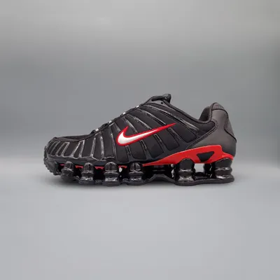 A side view of a Nike Shox TL sneaker against a plain gray background.