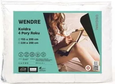 Packaging for a Wendre duvet with a woman reading in bed.