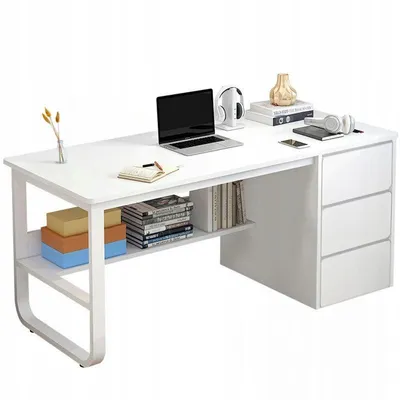 A white desk with a laptop, headphones, books, and decorative items.